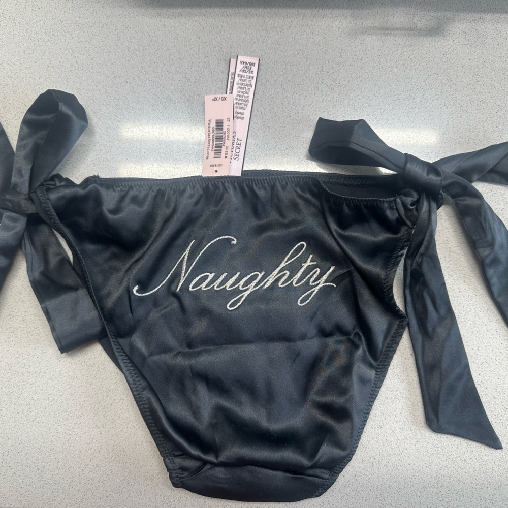 Black satin “Naughty” Victoria Secret panties